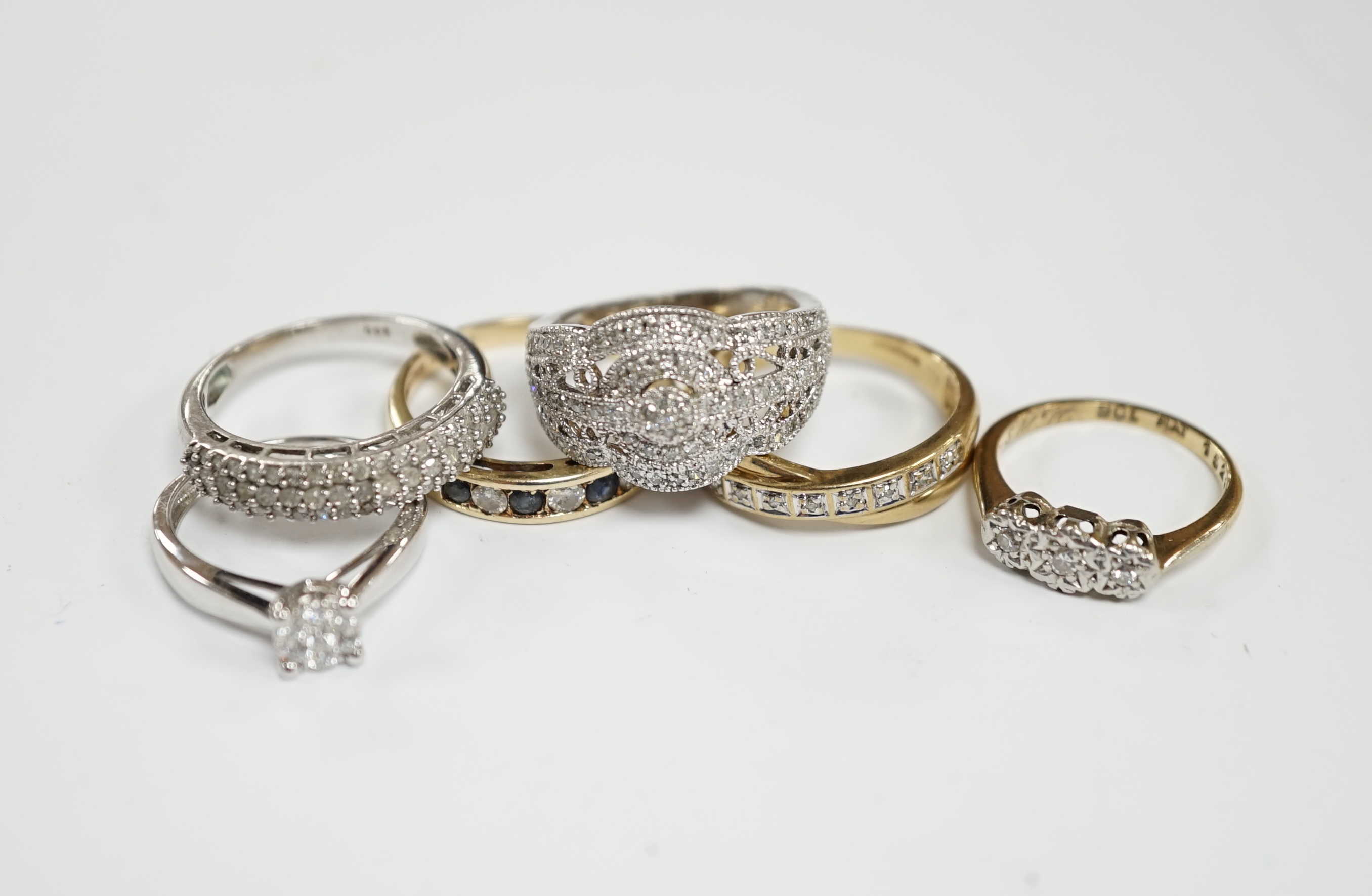 Five assorted modern 9ct and gem set rings including diamond chip cluster and sapphire and diamond chip, gross weight 12.7 grams, together with a 925 and diamond chip cluster set ring.
